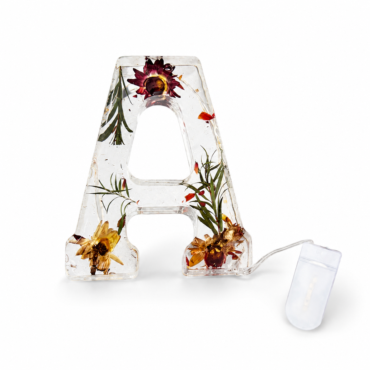 Lámpara de resina con letra y flores secas